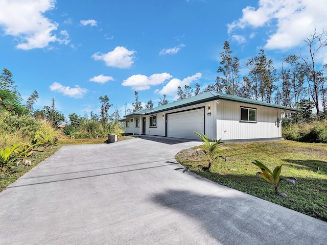 ranch-style house with a garage and a front lawn