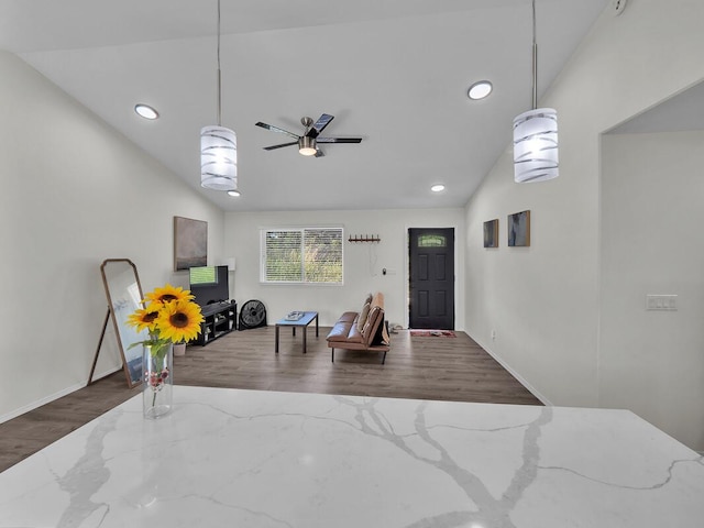 foyer entrance featuring lofted ceiling, hardwood / wood-style floors, and ceiling fan