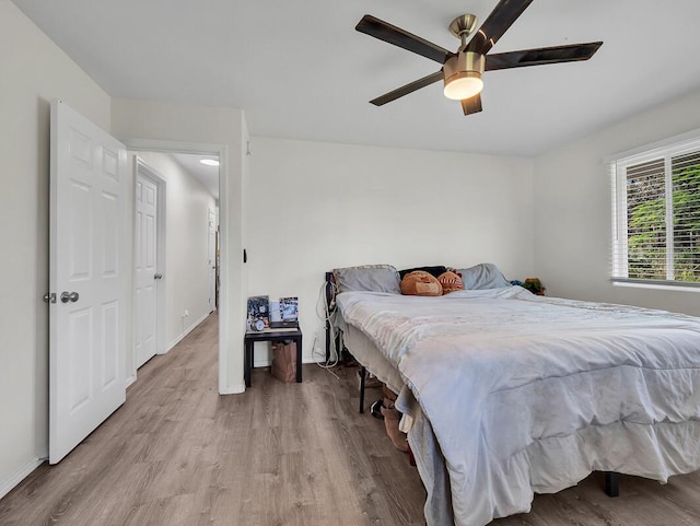 bedroom with light hardwood / wood-style floors and ceiling fan