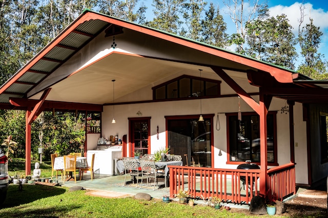 back of property with washing machine and dryer, a lawn, and a patio area