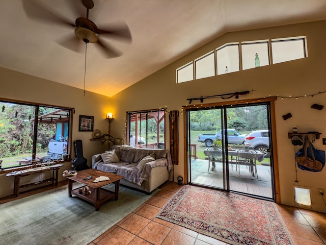 living room with light tile patterned flooring, ceiling fan, and high vaulted ceiling