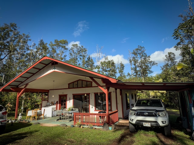 back of house with a carport