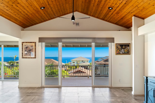 interior space with wood ceiling, a wealth of natural light, vaulted ceiling, and a water view