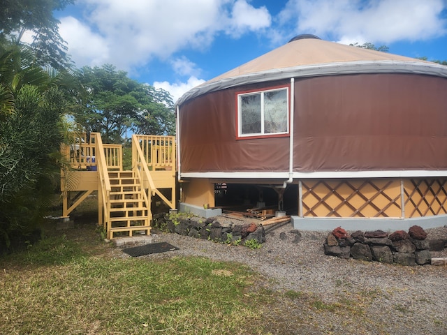 view of home's exterior with a wooden deck