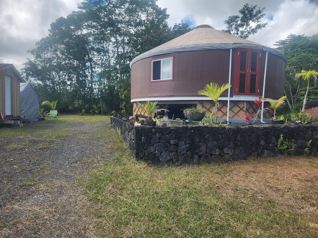 view of side of home with a lawn