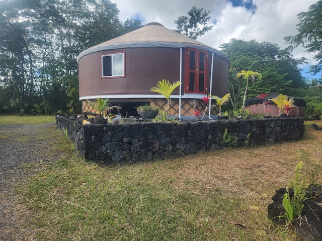 view of property exterior featuring a yard and a gazebo