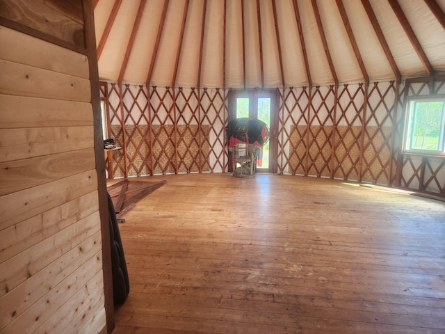 interior space with high vaulted ceiling and light hardwood / wood-style flooring