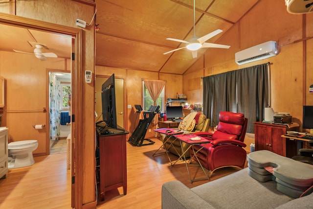 interior space featuring vaulted ceiling, a wall mounted AC, light hardwood / wood-style floors, and multiple windows