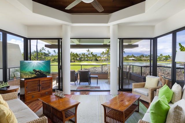 sunroom / solarium featuring wooden ceiling, a raised ceiling, and ceiling fan