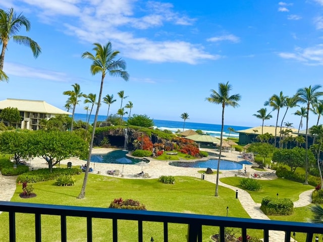 view of community featuring a water view and a lawn