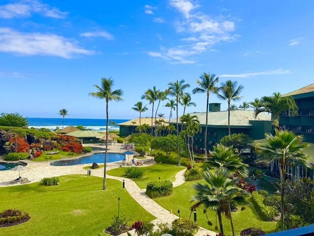 view of community with a lawn and a water view