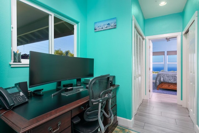 office featuring baseboards and wood finished floors