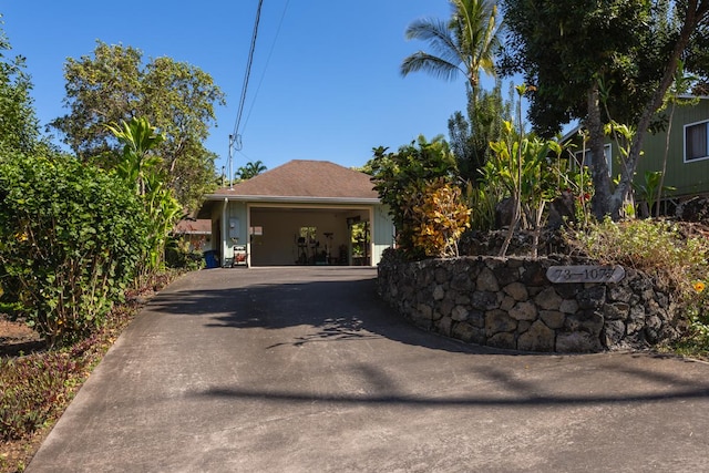 exterior space with a garage and concrete driveway