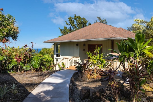 view of front of home with covered porch and roof with shingles