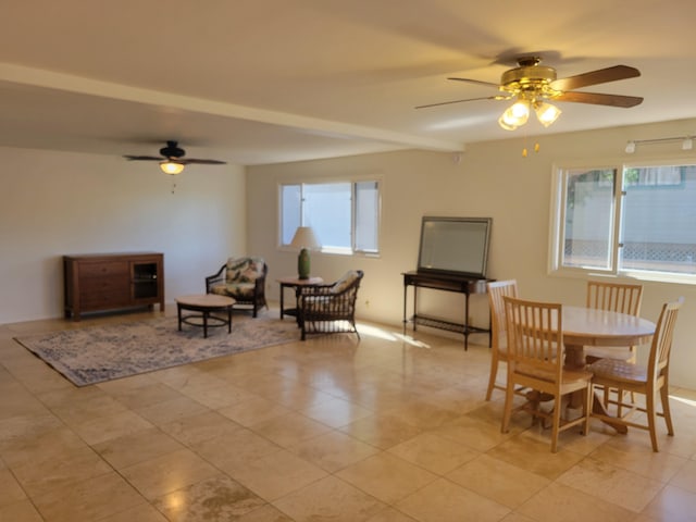 dining room with beam ceiling and ceiling fan