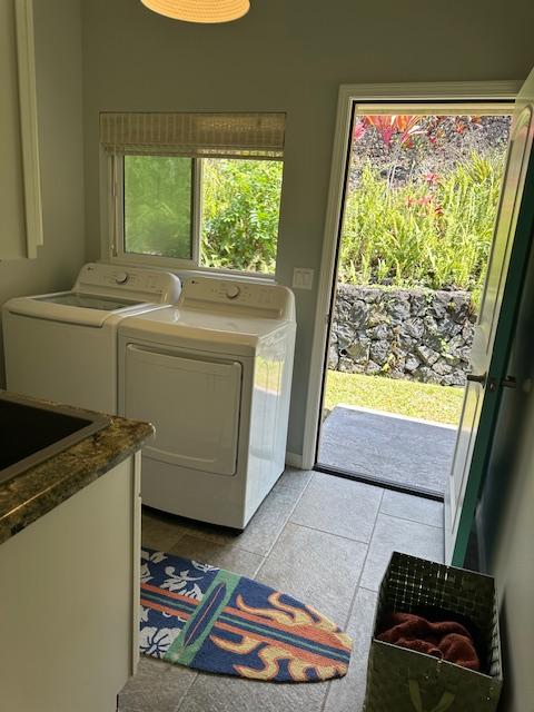 washroom featuring light tile patterned flooring and washing machine and dryer