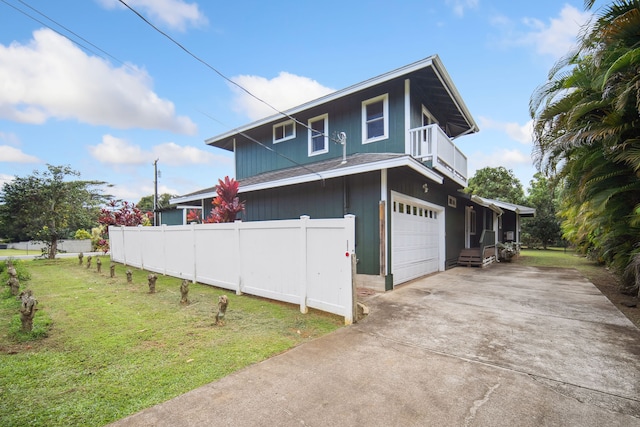 view of property exterior with a yard, a garage, and a balcony