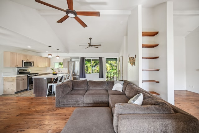 living room with ceiling fan, sink, high vaulted ceiling, and light hardwood / wood-style flooring