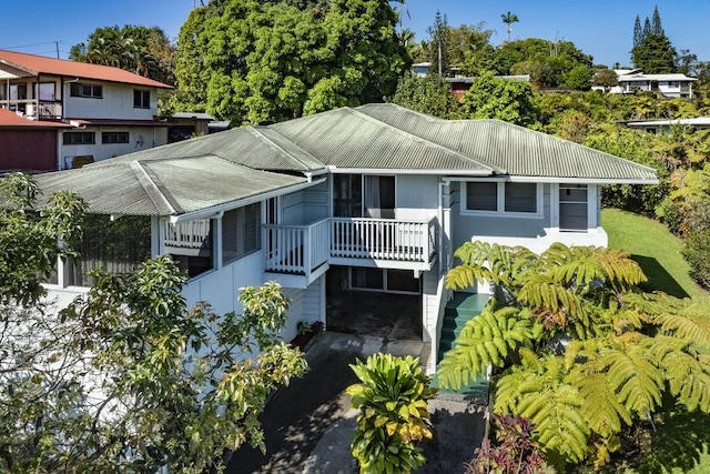 rear view of property with metal roof