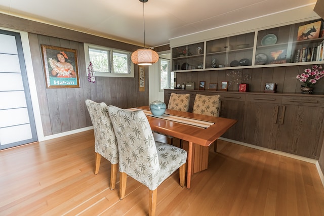 dining room with light wood finished floors and baseboards