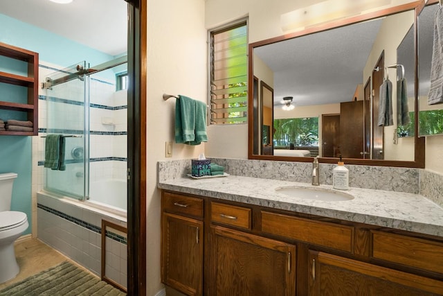 full bathroom featuring vanity, toilet, and combined bath / shower with glass door