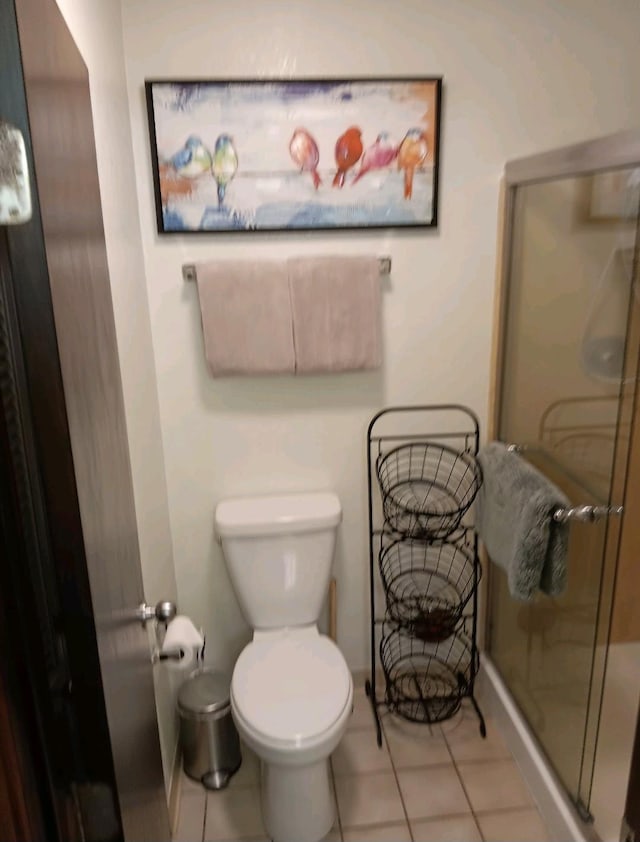 bathroom with walk in shower, tile patterned floors, and toilet