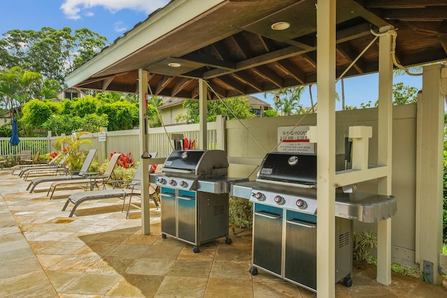 view of patio with area for grilling and a gazebo