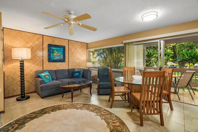 living room with ceiling fan and a textured ceiling