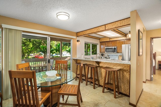 dining space with a textured ceiling