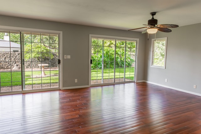 empty room featuring dark hardwood / wood-style floors and ceiling fan