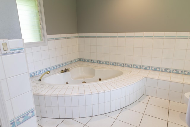 bathroom featuring tile patterned flooring and tiled tub