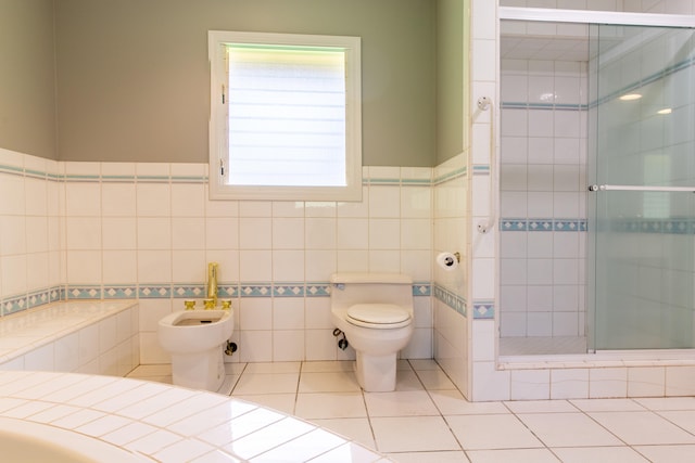 bathroom featuring an enclosed shower, tile patterned floors, toilet, tile walls, and a bidet