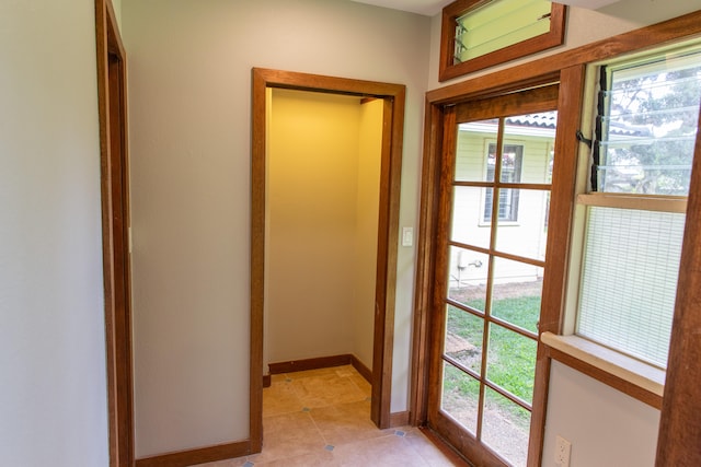 doorway to outside featuring light tile patterned flooring