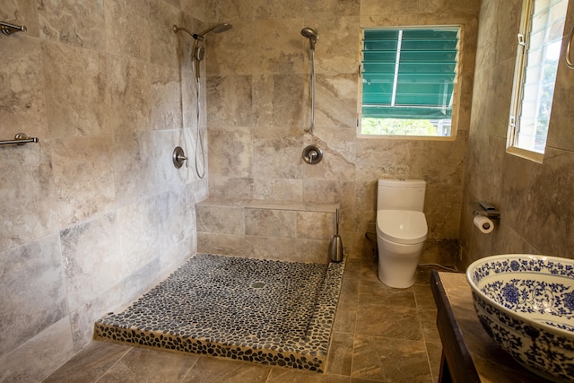 bathroom with toilet and tiled shower