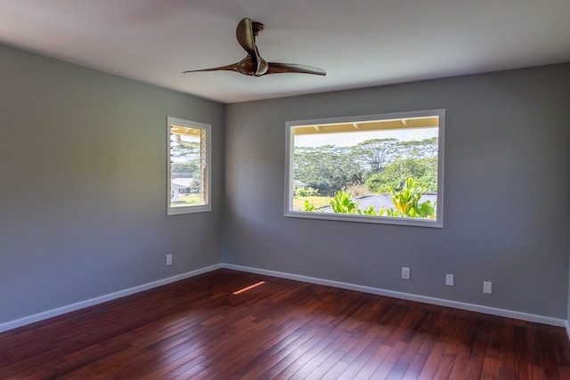 spare room with ceiling fan and dark hardwood / wood-style floors