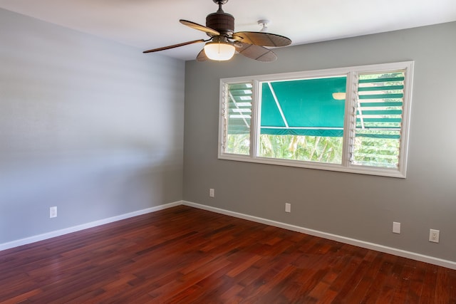 empty room featuring ceiling fan and dark hardwood / wood-style floors