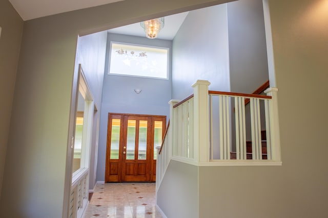 entrance foyer with a notable chandelier and a high ceiling