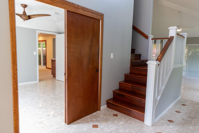 staircase featuring a healthy amount of sunlight, vaulted ceiling, and ceiling fan