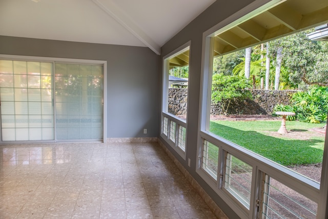 unfurnished sunroom with lofted ceiling