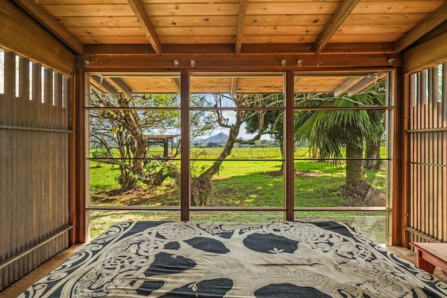 unfurnished sunroom featuring wood ceiling and beam ceiling