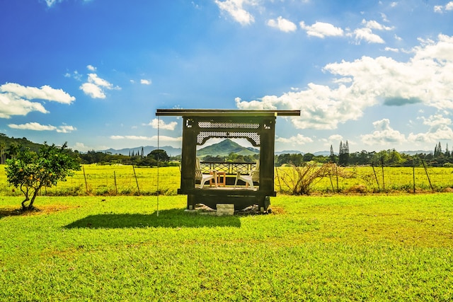 surrounding community featuring a rural view, a lawn, a gazebo, and a mountain view