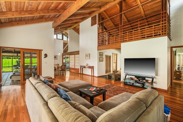 living room with french doors, beam ceiling, visible vents, wood finished floors, and wooden ceiling