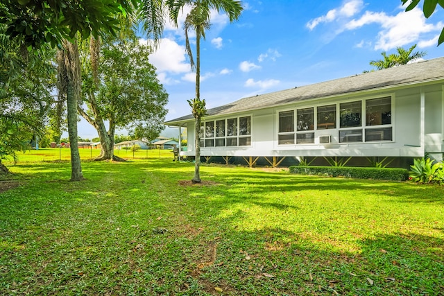 rear view of property with a yard