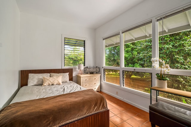 bedroom with baseboards and light tile patterned floors