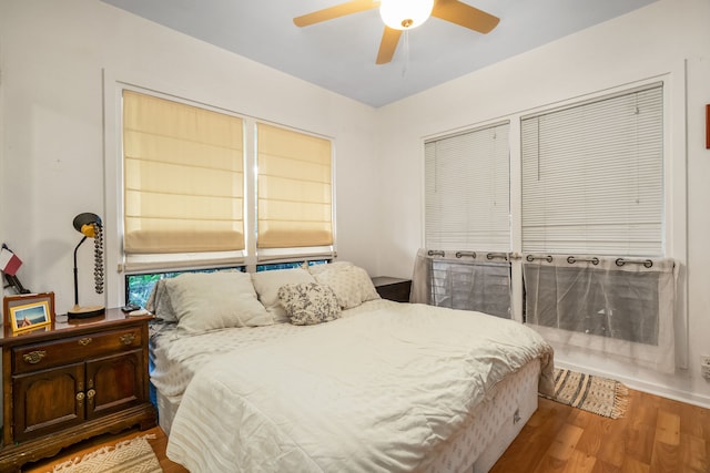 bedroom with a ceiling fan and light wood-style flooring