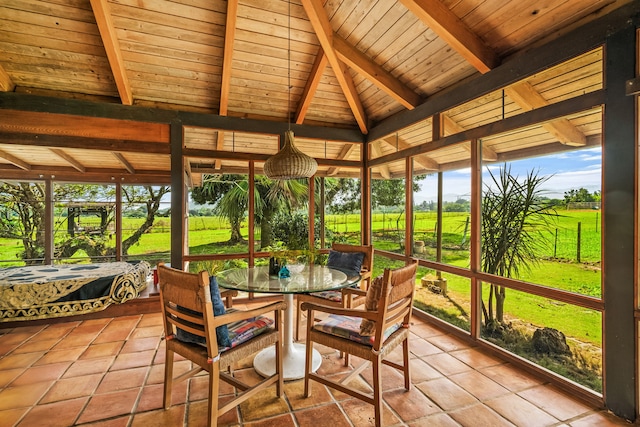 sunroom / solarium with wood ceiling, beam ceiling, and a rural view