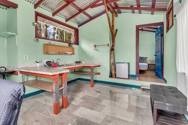 interior space featuring lofted ceiling and sink