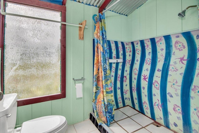 bathroom featuring toilet and tile patterned flooring