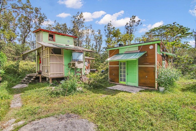 exterior space with a lawn and an outbuilding