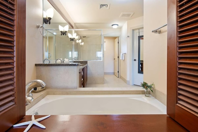 bathroom with vanity and a tub to relax in